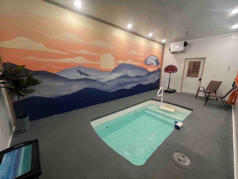 Indoor heated pool with a painted mural by a local artist