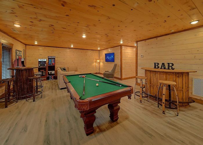 Game room with a pool table and bar area