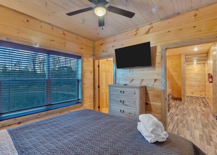 King bedroom with bath and TV in rental cabin