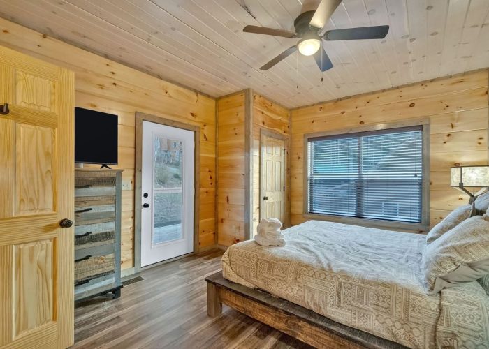Cabin bedroom with TV and private balcony
